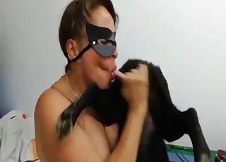 Unapologetic zoophile in a black mask sucking on a dog's juicy penis