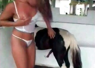 Zoophile babe with small tits gets ready for zoo porn with a horse