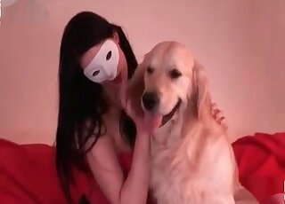 Brunette in a white mask lets this dog eat her out on a couch