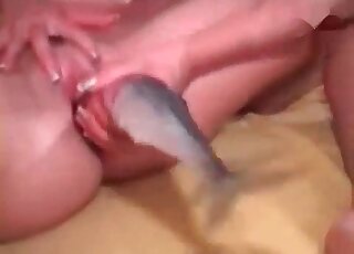 Bitchy MILFgets pleasure of being fucked by a fish in a homemade video